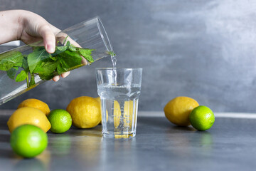 Homemade citrus refreshing summer lemonade drink with lemon, lime and mint in mason jars. Taste of summer.  Drinking in the heat