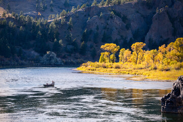 Fishermen rowing boat on Missouri River in autumn, Montana