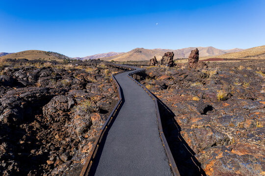 Winding paved walkway crossing Craters Of The Moon National Monument lava field
