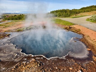 Blue geothermal pool in volcanic landscape in Iceland