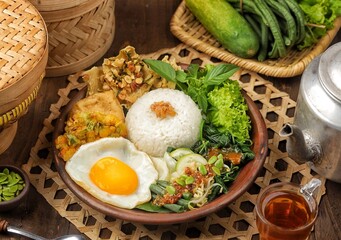 Nasi pecel or sega pecel is a typical Javanese Indonesian rice dish served with pecel.