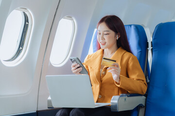 Travel and business tourism concept. Asian businesswoman holding credit card and smartphone...