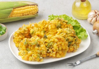 Perkedel Jagung or Bakwan Jagung, corn fritters is Indonesian traditional food. Savory snack made of corn, egg, flour, spring onion, pepper and salt.