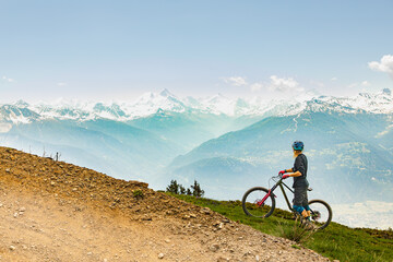 Biker enjoys breathtaking alpine view while paused