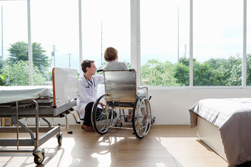 Senior white woman patient receives emotional and physical support from physician in medical room,...