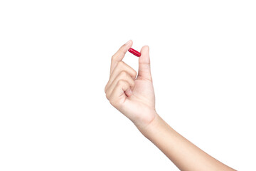 A female hand holding up a red medicine capsule or pill for health and wellness treatment, isolated...
