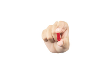 hand holding and showing a red medicine capsule or pill forward to the camera for treatment,...