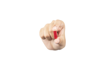 hand holding and showing a red medicine capsule or pill forward to the camera for treatment, isolated on white background with clipping path.