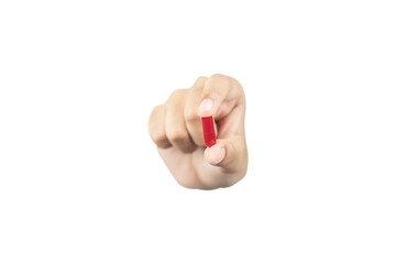 hand holding and showing a red medicine capsule or pill forward to the camera for treatment,...