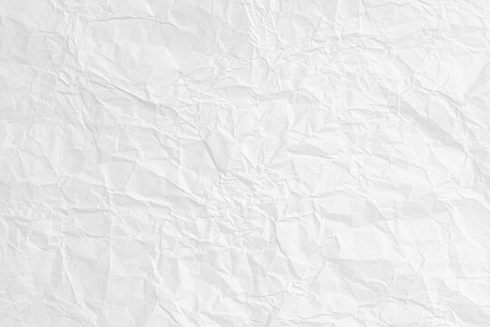 Abstract background of a white crumpled paper sheet. Blank wrinkled surface for a design and texture overlay.