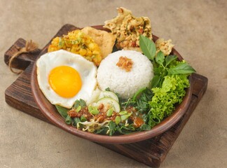 Nasi pecel or sega pecel is a typical Javanese Indonesian rice dish served with pecel.