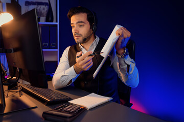 Smart businessman wearing headphones, remote meeting paperwork report folder online on pc,...