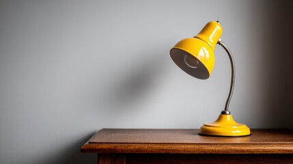 A yellow lamp sitting on top of a wooden table