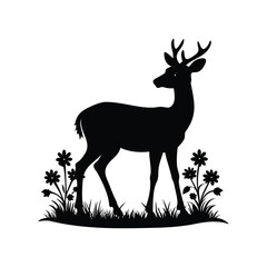 Silhouette of a young buck in a field of flowers and grass