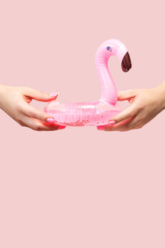 Summer vibes with inflatable flamingo on pink background