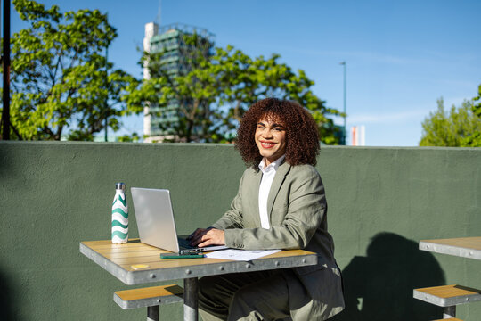 Trans woman working remotely outdoors