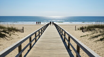Serene Beach Walkway: Sunlit Sands, Ocean Vista, and Silhouetted Figures