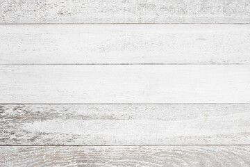 The white wooden walls have a peeling paint texture.