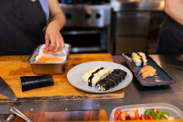 Sushi creation with fresh ingredients in restaurant setting
