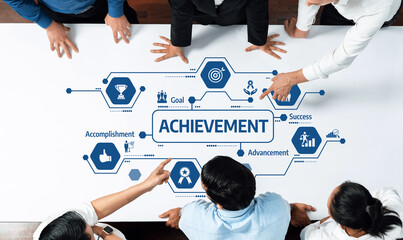 A top-down view of a diverse team discussing achievement strategies in a modern workspace,...