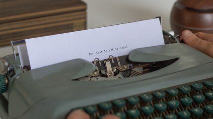 Close-up of a vintage typewriter with the inspirational quote the best is yet to come being typed...