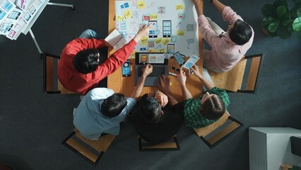 Top view of smart creative project manager using laptop working on Ux Ui design for mobile phone...