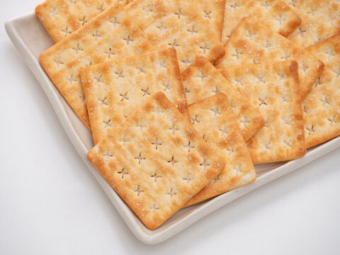 Square Salted Crackers on White Ceramic Plate