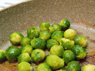 Juicy, bright green Brussels sprouts in a pan. Close