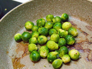 Juicy, bright green Brussels sprouts in a pan