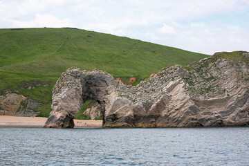 An unusual seaward view of the famous natural arch called Durdle Door on a calm day: Jurassic...