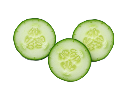 Three fresh, thinly sliced cucumbers with emerald green rinds, pale green flesh, and visible seeds, presented as distinct circular shapes on a bright transparent background with copy space,