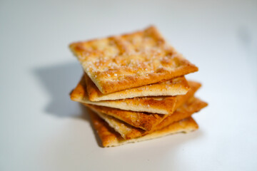 Whole wheat biscuits stacked together on a white background