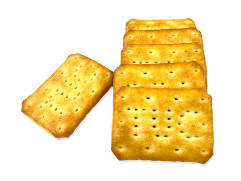 Artistically arranged golden biscuits isolated on the white background