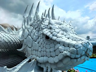 White Naga Head Statue with Cloudy Sky in Thailand Wat Don Yai 