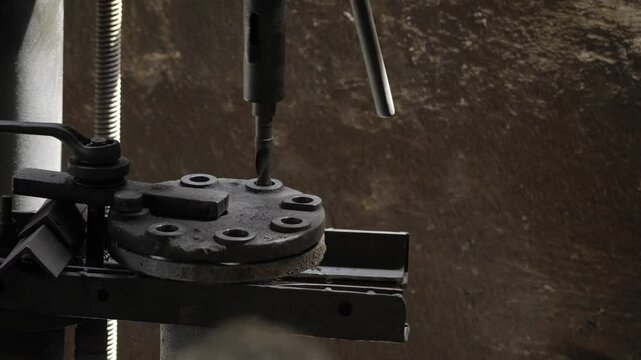 Precision Machinery in Action - Drill Bit Sinking into Metal Plate