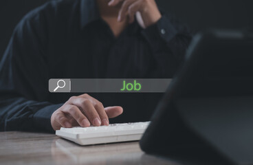 Businessman searching for jobs on a digital platform using keyboard with green "Job" highlighted on search bar, representing career exploration, employment opportunities, and digital job hunting.