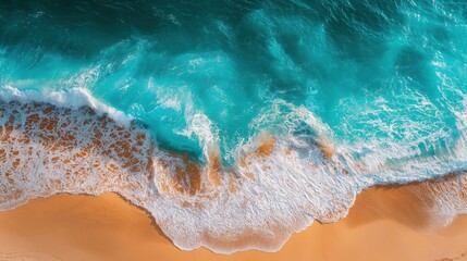 Vibrant turquoise ocean water with white foamy waves meeting the serene golden beach