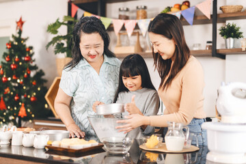 Grandmother cooking with daughter and mother family fun at home kitchen