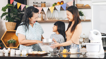 Grandmother cooking with daughter and mother family fun at home kitchen