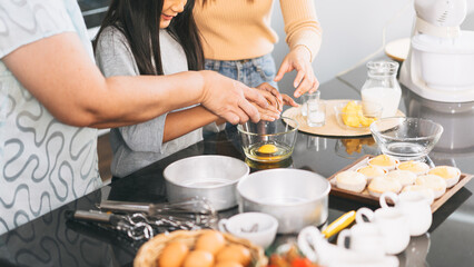 Grandmother cooking with daughter and mother family fun at home kitchen