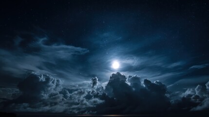 Naklejka premium Moon shines through clouds in a dark night sky over a body of water.