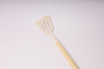 Kitchen White spatula on isolated white background. White silicone spatula with wooden handle....
