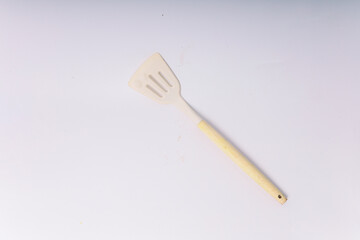 Kitchen White spatula on isolated white background. White silicone spatula with wooden handle....