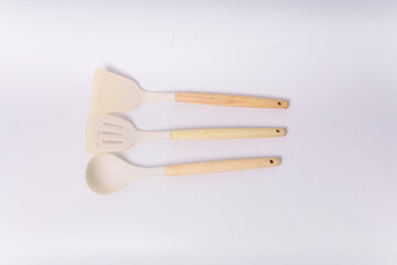 White Silicone cooking utensils set with wooden handle isolated on white background. Kitchen tool...