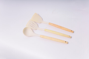 White Silicone cooking utensils set with wooden handle isolated on white background. Kitchen tool...