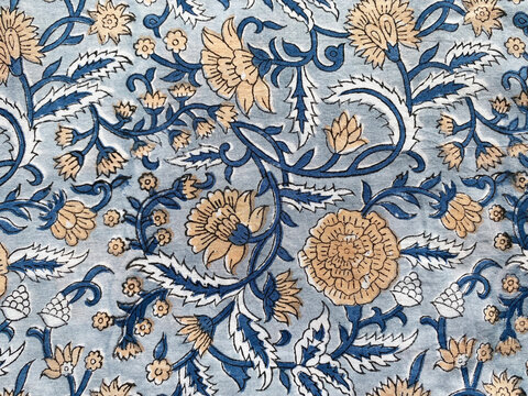 Intricate Mughal floral motifs in calming blue and beige tones are delicately block printed on soft cotton fabric.