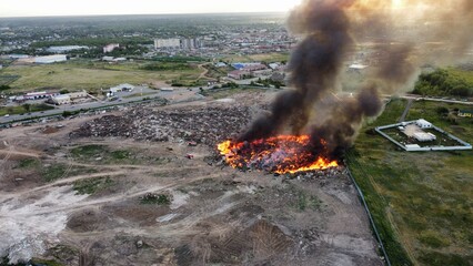 Landfill Fire with Heavy Smoke and Firefighting Equipment – Aerial View
