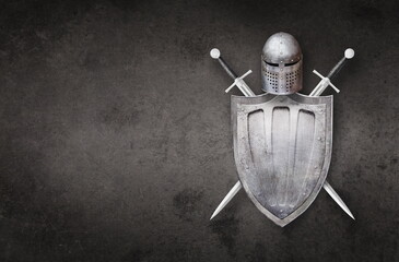 knight helmet shield and two swords on grunge background