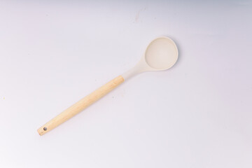 White silicone kitchen soup ladle isolated on white background. Kitchen utensils