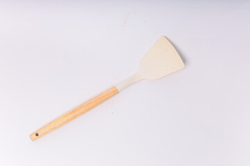 Kitchen White spatula on isolated white background. White silicone spatula with wooden handle....